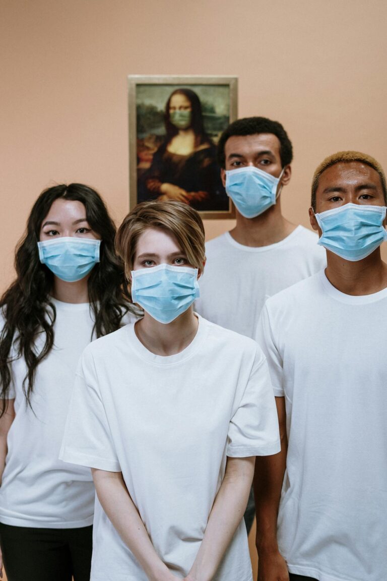 Group of healthcare professionals wearing masks in front of Mona Lisa painting for COVID-19 awareness.